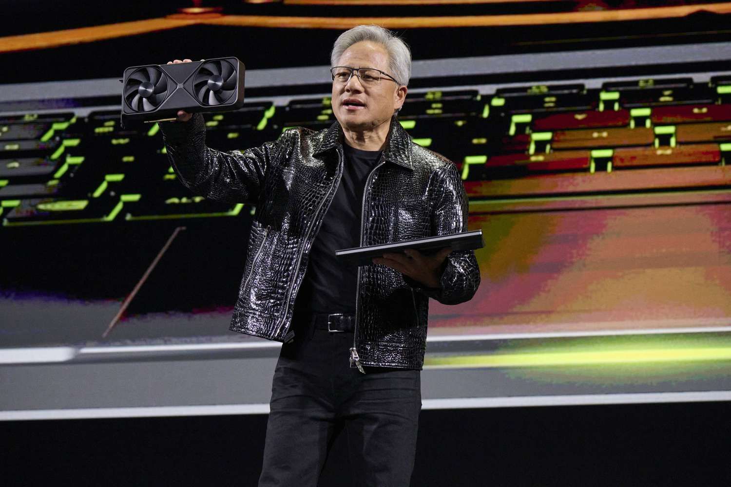 NVIDIA CEO Jensen Huang presenting a graphics card on stage